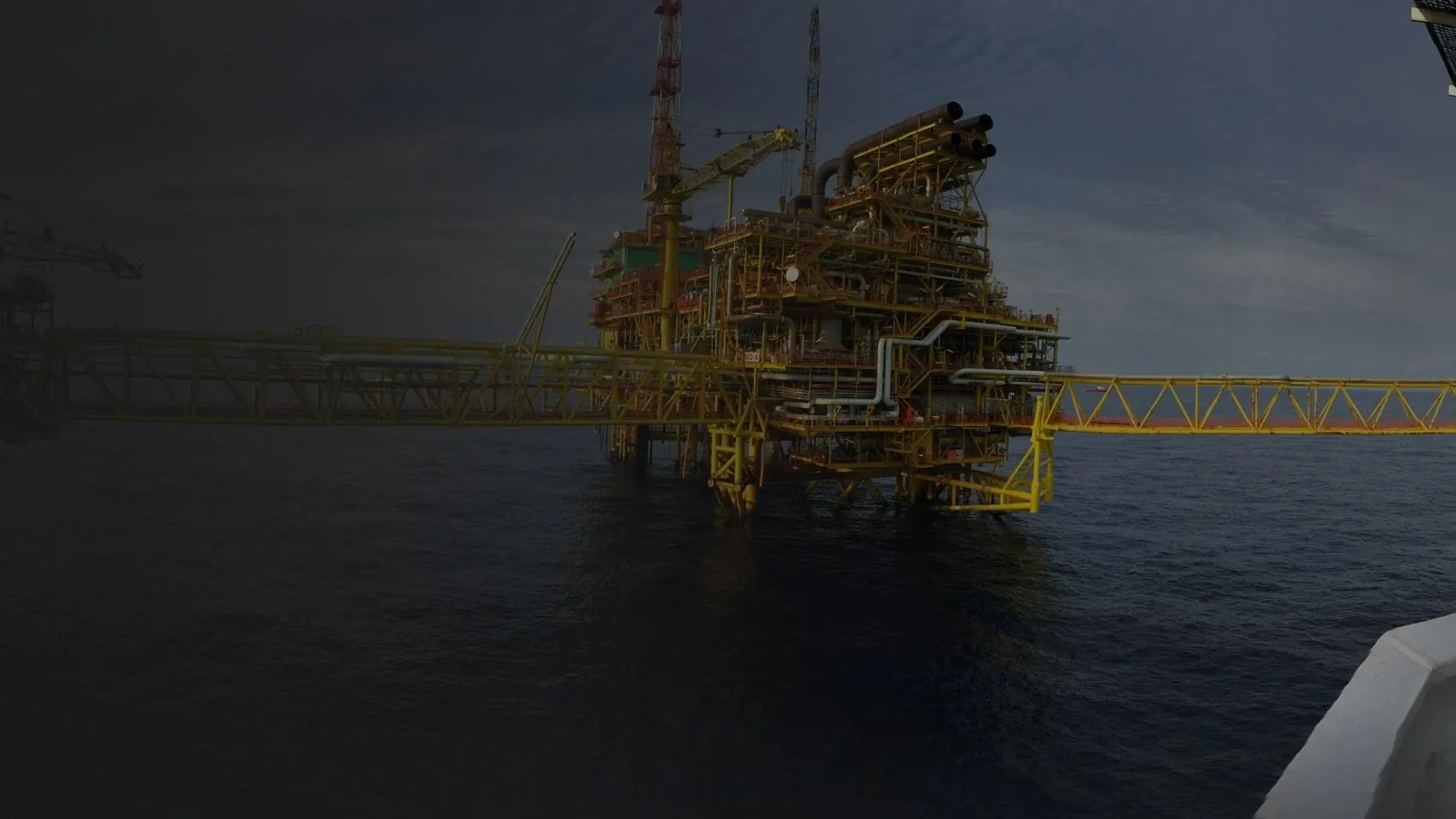 Offshore process decks, jacket and connecting bridge viewed from an adjacent structure