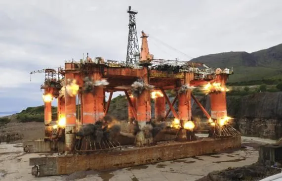 A large offshore structure being dismantled at an onshore site
